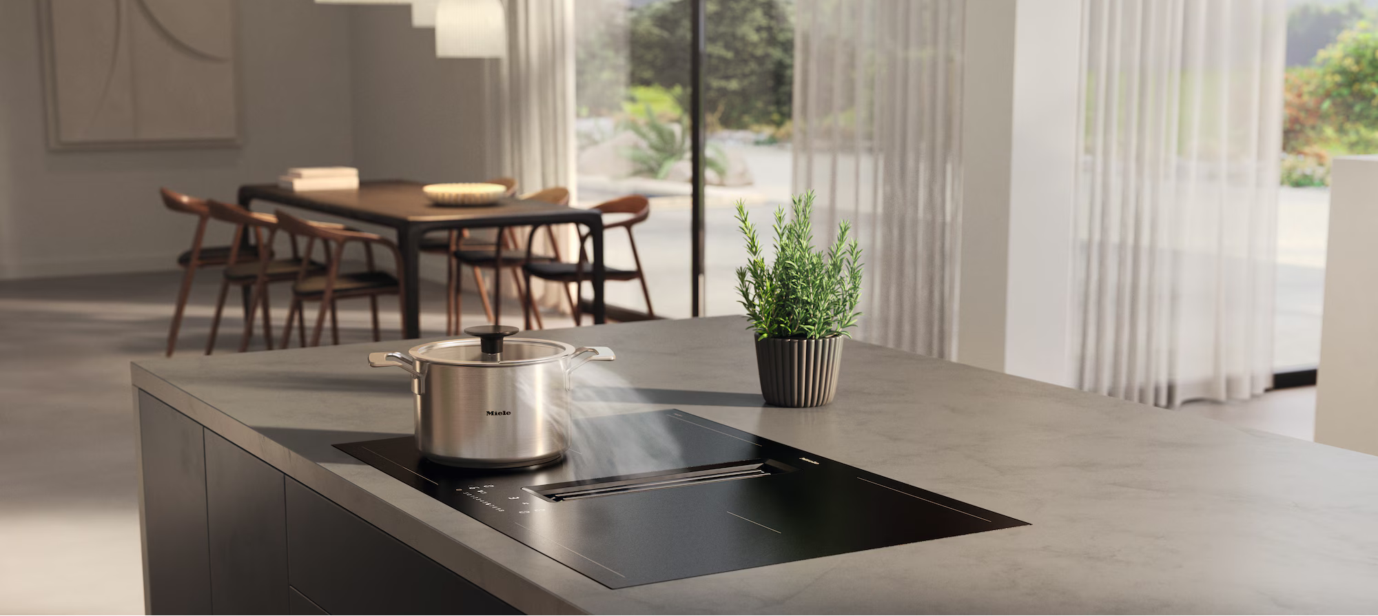 Modern kitchen with a stove and a view of a dining area through large windows.