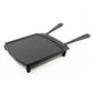 Black grill pan with two handles on a white background