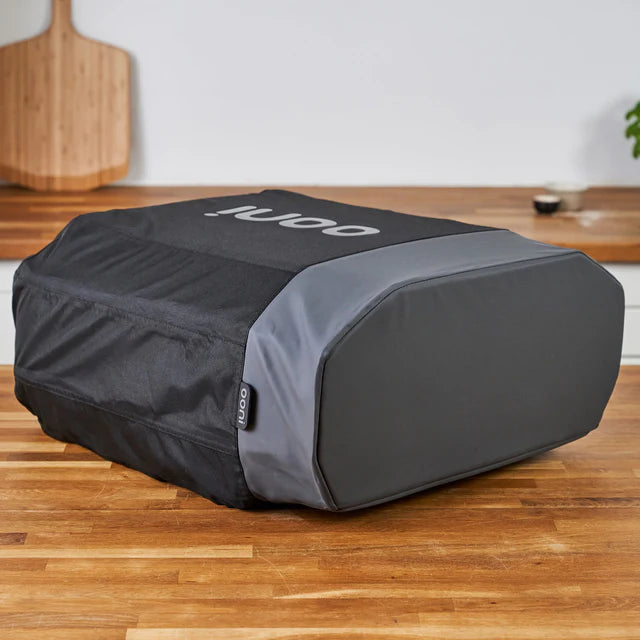 Black and gray cooler bag with 'Noco' branding on a wooden surface.