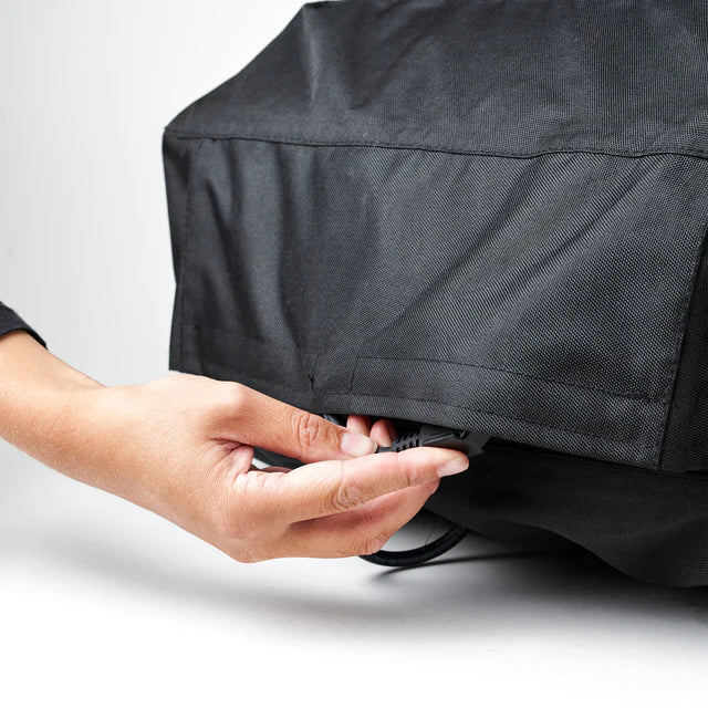 Person adjusting a the volt pizza oven cover